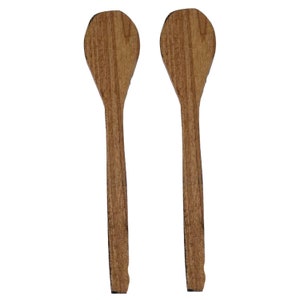 May include: Two wooden spoons with brown and light brown wood grain. The spoons are about 10 inches long.