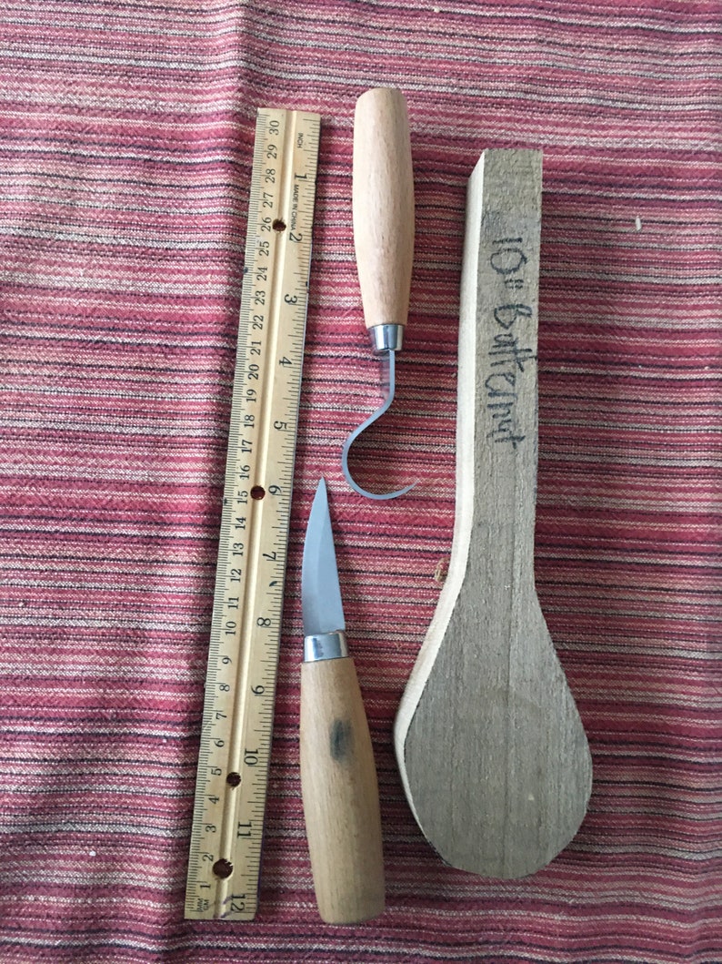 May include: Two wood carving tools with wooden handles and a wooden spoon blank labeled "10" Butternut".