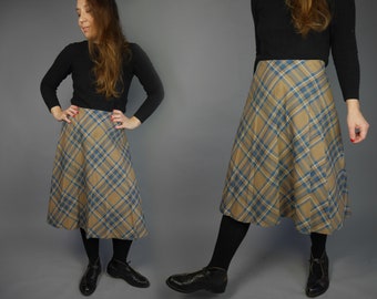 May include: A brown and blue plaid skirt with a flared silhouette. The skirt is knee-length and has a high waist.