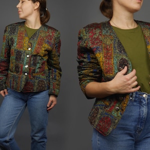 May include: A multi-coloured patterned blazer with a button closure. The blazer has a dark green, red, blue and yellow pattern.