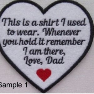 May include: A heart-shaped patch with a black border and white center. The patch features the text "This is a shirt I used to wear. Whenever you hold it remember I am there, Love, Dad" and a red heart.