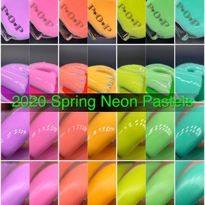 May include: A collection of neon pastel nail polish bottles in various shades, including purple, pink, orange, yellow, and green. Each bottle is labeled with "P+O+P" and the text "2020 Spring Neon Pastels" is displayed in green.