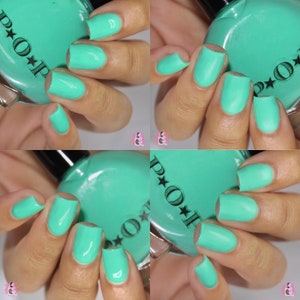May include: Four images of manicured nails painted in a vibrant, opaque turquoise nail polish. The polish is applied evenly, with a glossy finish. The nail polish bottle is visible, with the brand name "POP" and star details.