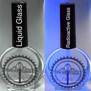 May include: Two bottles of nail polish, one clear and one glowing blue. The clear bottle is labeled "Liquid Glass" and the blue bottle is labeled "Radioactive Glass". Both bottles have black caps and the same label design with "P.O.P Polish" and "15mls".