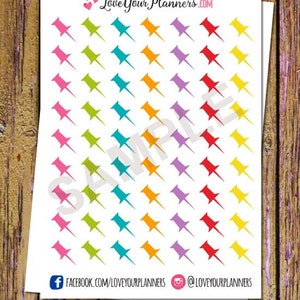 May include: A sheet of colorful push pin stickers with a white background. The stickers are arranged in rows of five, with each row featuring a different color: pink, green, blue, orange, and purple. The text "LoveYourPlanners.com" is printed at the top of the sheet.