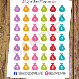 May include: A sheet of colorful money bag stickers. The stickers are in various colors, including purple, orange, pink, green, red, and blue. Each sticker features a simple outline of a money bag with a dollar sign inside.