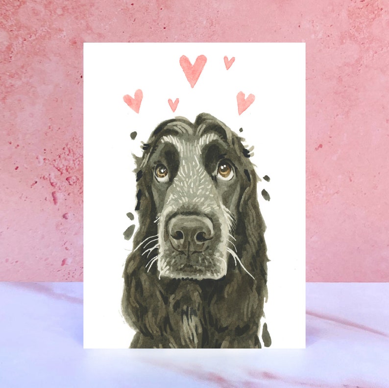 May include: A watercolor painting of a black and gray cocker spaniel with pink hearts floating above its head. The dog is looking up with a sweet expression.