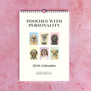 Puede incluir: Calendario de espiral de 2026 titulado "Pooches With Personality", con retratos de acuarela de varias razas de perros. El calendario incluye imágenes de un golden retriever, un schnauzer y otros perros. El nombre del artista, Robert James Hull, está impreso en la parte inferior.