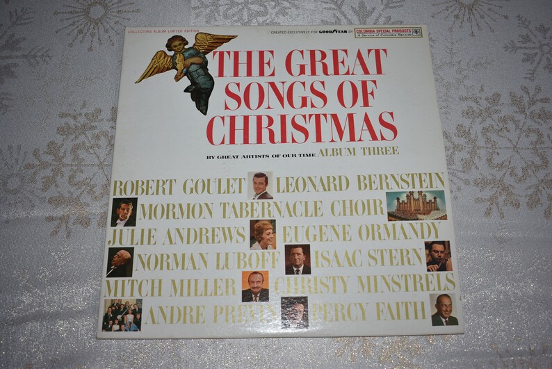 May include: A white vinyl record album cover with a red title "The Great Songs of Christmas" and a picture of an angel. The album features a collection of Christmas songs by artists including Robert Goulet, Leonard Bernstein, Mormon Tabernacle Choir, Julie Andrews, Eugene Ormandy, Norman Luboff, Isaac Stern, Mitch Miller, Christy Minstrels, Andre Previn, and Percy Faith.