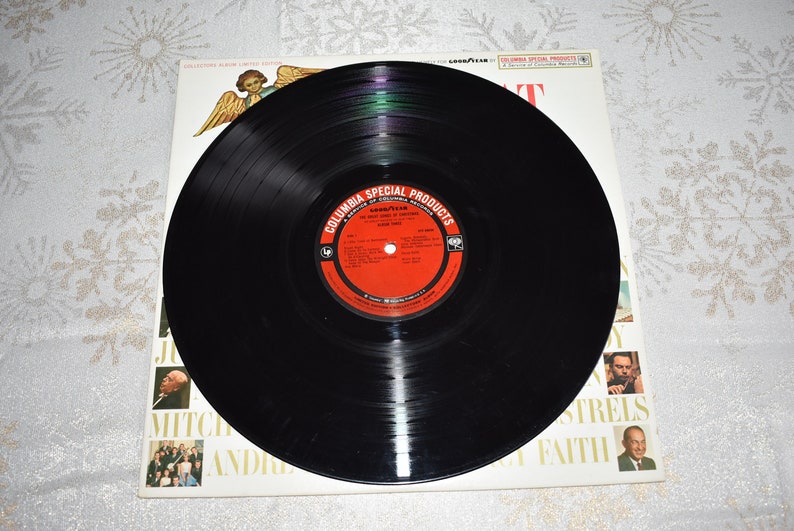 May include: A black vinyl record with a red label that says "Columbia Special Products" and "The Sound of Christmas" with a picture of a Christmas angel on the cover.