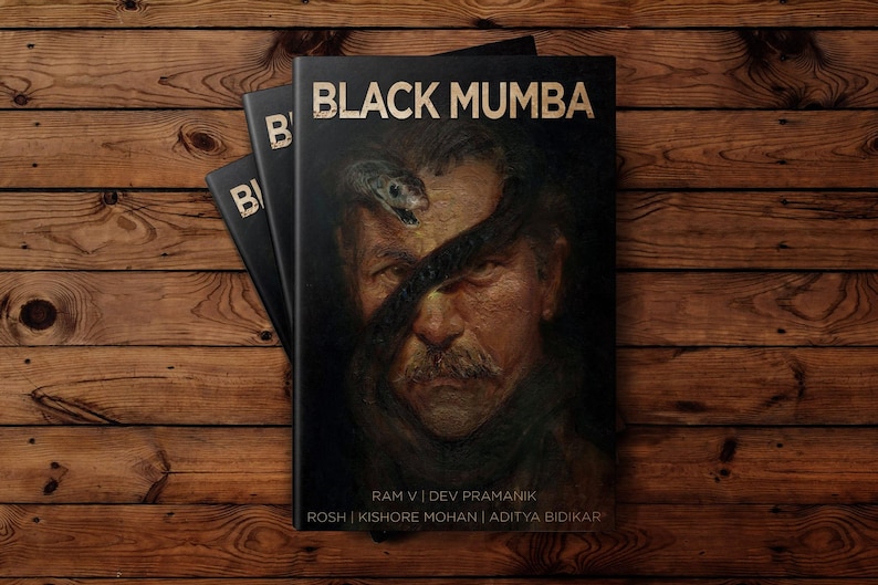 May include: Three black books titled "BLACK MUMBA" in gold lettering. The cover art depicts a man's portrait with a snake across his face. The books are stacked on a wooden surface.