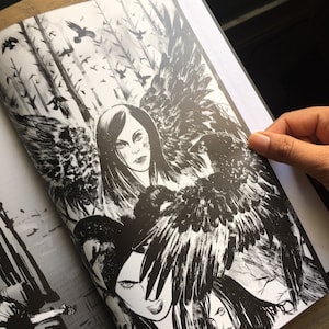 May include: Monochrome illustration of a woman with raven wings and long dark hair. The artwork has a gothic theme with crows and a forest background. The image is from a book or print.