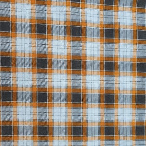 May include: Close-up of a fabric with a plaid pattern. The design features a grid of intersecting lines in orange, gray, and light blue. The fabric has a woven texture, with the colors creating a visually appealing checkered effect.