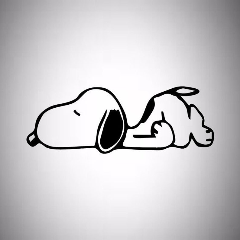 May include: A black and white illustration of Snoopy, the cartoon beagle, lying down. The dog is in a relaxed pose, with his eyes closed and his body curved. The image is a simple, minimalist design.