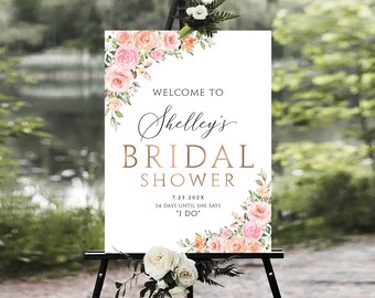 Puede incluir: Un cartel blanco con decoraciones florales de color rosa y melocotón. El cartel dice "Bienvenido al Shower Nupcial de Shelley 7.23.202X 54 Días Hasta Que Ella Dice "Sí, Quiero""