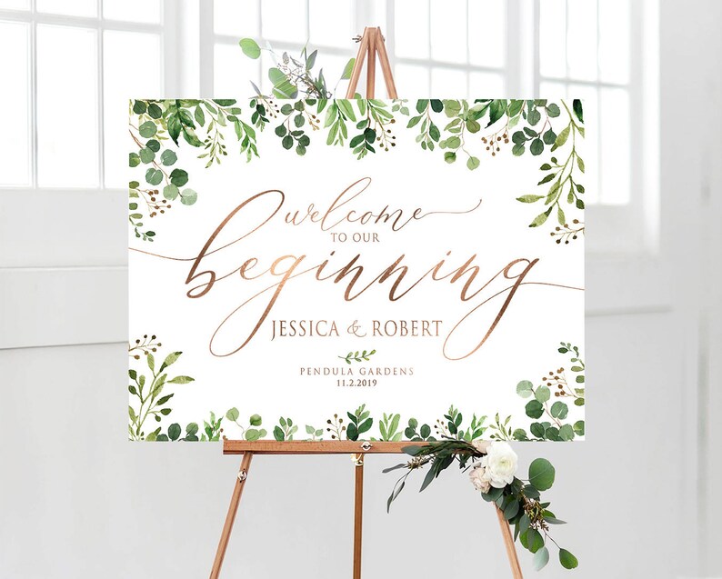 May include: Welcome to our beginning wedding sign with greenery and gold lettering. The sign reads "Welcome to our beginning Jessica & Robert Pendula Gardens 11.2.2019".