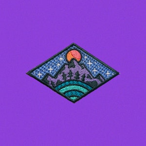 May include: A diamond-shaped embroidered patch with a purple mountain range, a bright orange sun, and white stars on a dark blue background.