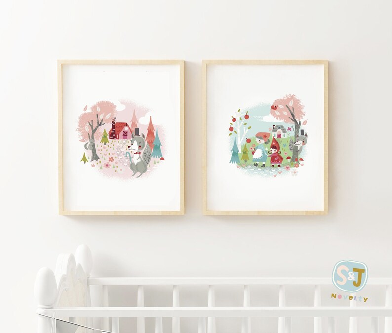 May include: Two framed illustrations of woodland scenes. The first shows a gray fox wearing a top hat and holding a walking stick in a pink and green forest. The second shows a girl in a blue dress and a girl in a red hooded cloak walking in a green forest with a gray wolf.