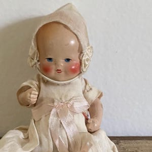 Vintage composition dollhouse doll baby hand painted jointed Germany doll with bonnet and doll dress collectible figurine