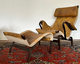 Pernilla leather lounge chair and footstool by Bruno Mathsson for Dux, 1960s