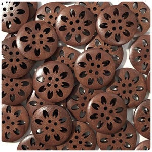 May include: A collection of round, wooden buttons with a flower-like design. Each button is a rich brown color and features cut-out petal shapes around the edge and a central hole. The buttons are scattered across a white surface.