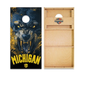 May include: A set of cornhole boards with a blue and yellow wolf graphic on one side. The graphic includes the word "MICHIGAN" and the World Series of Cornhole logo. The other side of the board is plain wood.