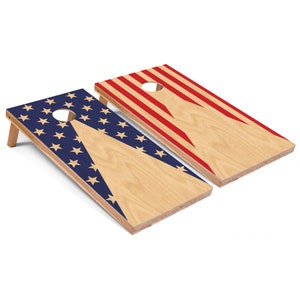 May include: Two wooden cornhole boards with an American flag design. One board has red and white stripes with a white triangle, and the other board has blue stars with a white triangle.