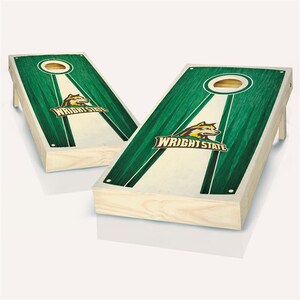 May include: Two wooden cornhole boards with a green and white striped design. The boards feature the Wright State University logo with a wolf mascot.
