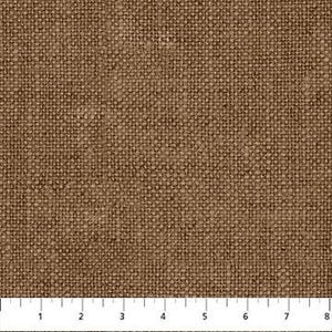 May include: Close-up of a brown woven fabric with a textured surface. A ruler is placed at the bottom, showing measurements in inches. The fabric appears to be a natural material, possibly linen or burlap.