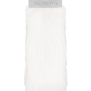 May include: White faux fur fabric with a tag that reads "Fun Fur Cuts". The fabric is a solid white color and has a soft, fluffy texture. The product is likely used for crafting or costume making.