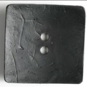May include: A large, square, dark gray button with two holes. The button has a textured surface with subtle wrinkles and imperfections. The button is likely made of a durable material.