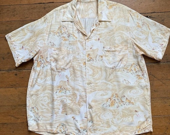 May include: A short-sleeved button-up shirt with a white background and a beige, brown, and yellow print of mountains, clouds, and birds.