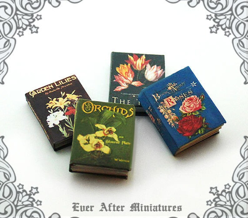 May include: Four miniature books with floral illustrations. The books are titled "Garden Lilies", "Orchids", "Book About Roses", and "The Iris".