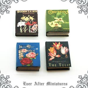 May include: Set of four miniature books with floral illustrations. The books are titled "Garden Lilies", "Orchids", "Book About Roses", and "The Tulip".