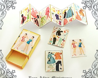 May include: A set of paper dolls with various outfits and accessories. The dolls are printed on cardstock and are ready to be cut out and played with. The set includes a booklet of outfits and a separate sheet with two dolls. The dolls are dressed in a variety of styles, including dresses, skirts, pants, and tops. The outfits are colorful and feature a variety of patterns and designs. The dolls are perfect for imaginative play and are sure to provide hours of fun.