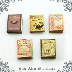 May include: A collection of miniature vintage books with titles like "The Modern Crochet Book", "Knitting How to Knit What to", "A Treatise on Embroidery", "Goubaud's Point Lace Book", and "The Dress You Wear".