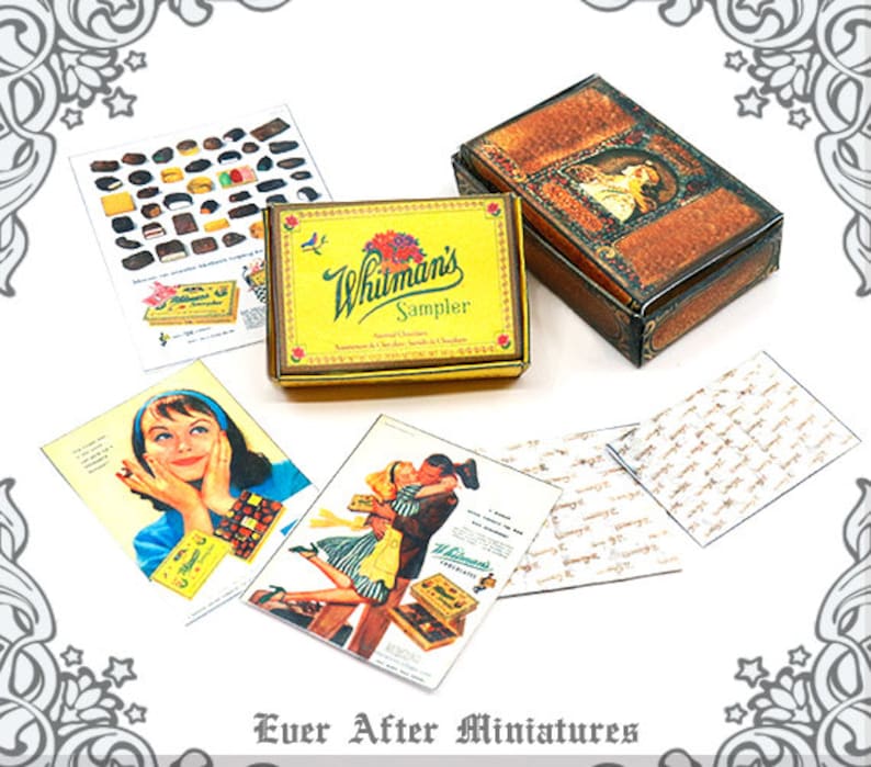 May include: A miniature replica of a Whitman's Sampler chocolate box, with a vintage design and a gold lid. The box is surrounded by miniature cards with images of people and chocolates.