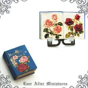 May include: Two miniature books with floral illustrations. The book on the left is blue with the title "Book About Roses". The book on the right is open to show pages with pink and red roses.