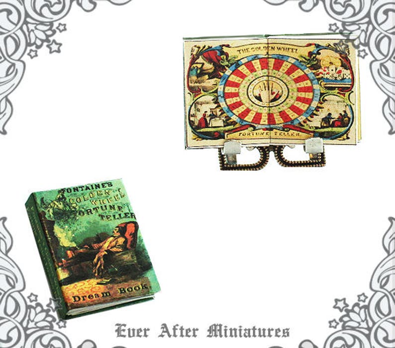 May include: Two miniature books, one titled "Fontaine's Golden Wheel Fortune Teller Dream Book" with a green cover and the other titled "The Golden Wheel Fortune Teller" with a colorful cover depicting a wheel of fortune.
