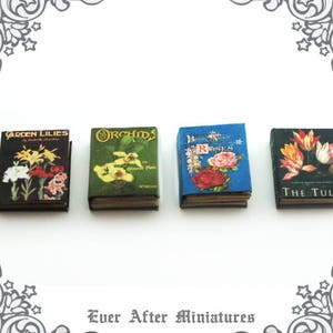 May include: Five miniature books with floral illustrations and titles. The books are "Garden Lilies", "Orchids", "Book of Roses", "The Tulip", and "The Tulip".