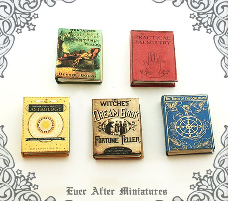 May include: Five miniature books with vintage covers. The books are titled "Fontaine's Golden Witch Fortune Teller", "Practical Palmistry", "Complete Book of Predictive Astrology", "The Witches Dream Book Fortune Teller", and "The Tarot of the Bohemians".