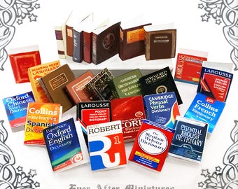 May include: A collection of miniature dictionaries in various languages, including Spanish, French, English, and Chinese. The dictionaries are arranged in a colorful display, with some stacked on top of others.