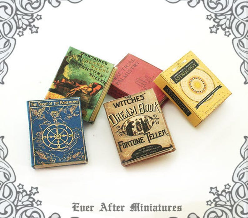 May include: A set of miniature books with vintage-inspired covers. The books include titles like "The Tarot of the Bohemians", "Fontaines Golden Witch Fortune Teller", "Practical Palmistry", "The Witches Dream Book Fortune Teller", and "Astrology".