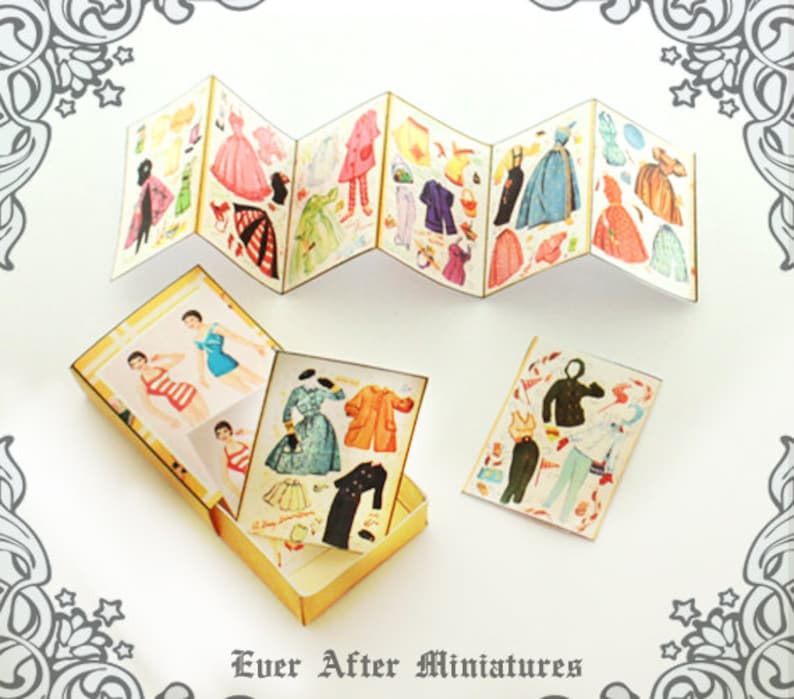 May include: A set of miniature paper dolls with various outfits and accessories. The dolls are in a vintage style and come in a small box with a gold trim. The box has the text "Ever After Miniatures" printed on the bottom.