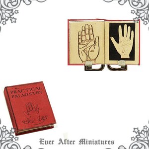 May include: A miniature red book titled "The Practical Palmistry" with a hand illustration on the cover.  The book is open to reveal two pages with hand illustrations and the text "The Practical Palmistry".