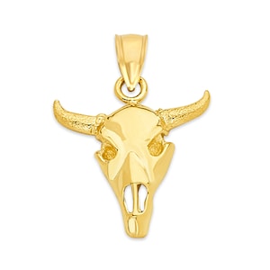 May include: A gold-toned bull skull pendant charm. The pendant is detailed with a textured surface and features a skull with horns.