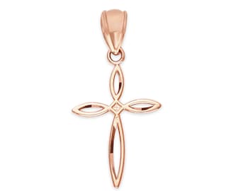 May include: Rose gold pendant in the shape of a cross. The cross design features a stylized openwork pattern with elongated, petal-like shapes. The pendant has a loop at the top for a chain.
