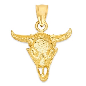 May include: A gold-toned bull skull pendant charm. The pendant is detailed with a textured surface and features a bail for attaching to a chain.