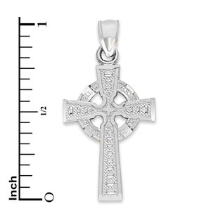 May include: Silver Celtic cross pendant with intricate detailing. The cross is approximately 1 inch in size.