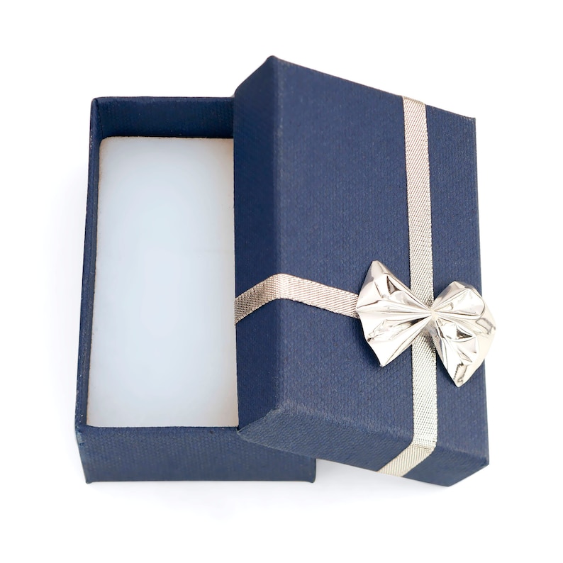 May include: An open blue gift box with a silver bow. The box is empty and ready to be filled with a special gift.
